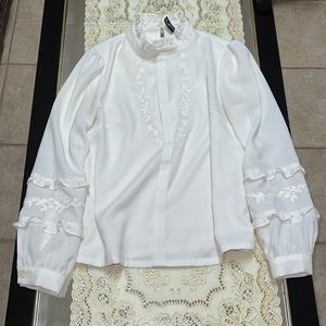 White high neck long-sleeved blouse with floral embroidery